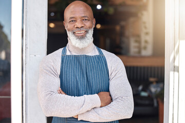 Black man, portrait smile and arms crossed in small business cafe or retail store by entrance door....
