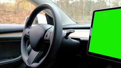 Interior dashboard with a modern interface design and steering wheel. Electronic dashboard tablet Green screen chromakey