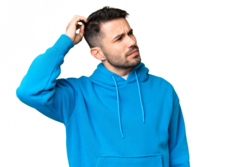 Young handsome caucasian man over isolated chroma key background having doubts while scratching head