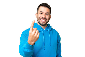 Young handsome caucasian man over isolated chroma key background doing coming gesture