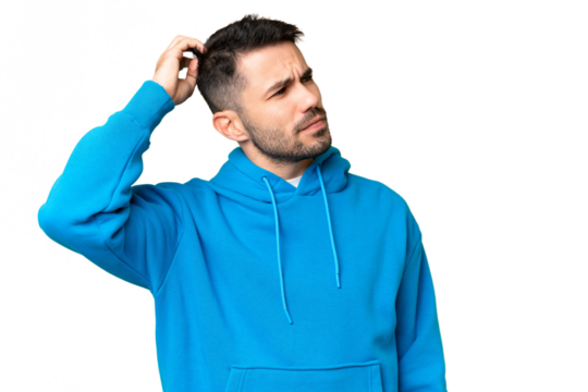 Young handsome caucasian man over isolated chroma key background having doubts while scratching head