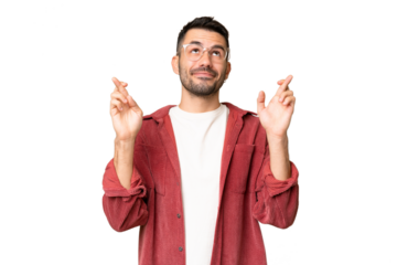 Young handsome caucasian man over isolated chroma key background with fingers crossing and wishing the best