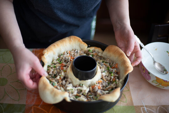 the hostess prepares a homemade pie stuffed with meat and vegetables