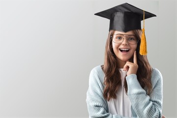 Happy cute child student wearing graduate cap