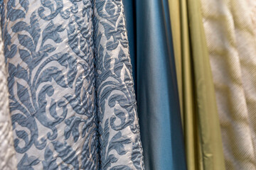 Samples of curtains in the salon. Modern trends in decor and interior design. Close-up. Selective focus.