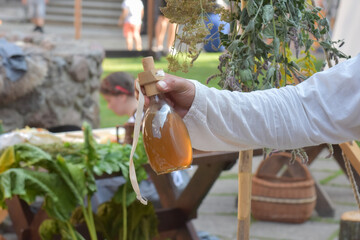 Traditional liquor held in the hand.