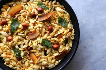 Jada Poha Namkeen Chivda or Thick Pohe Chiwda. Diwali special savory snack, made out of puffed rice, fried peanuts, curry leaves and some spices. Traditional Indian Diwali Snacks. with Copy Space.
