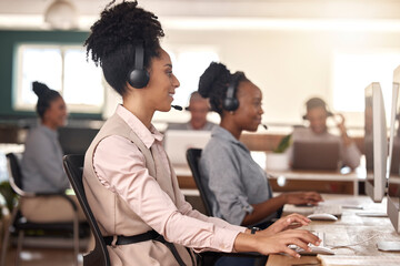 Call center, black woman and computer on desk in office for customer service, sales or support. Agent or consultant team in telemarketing, telecom and crm or help desk in coworking workplace