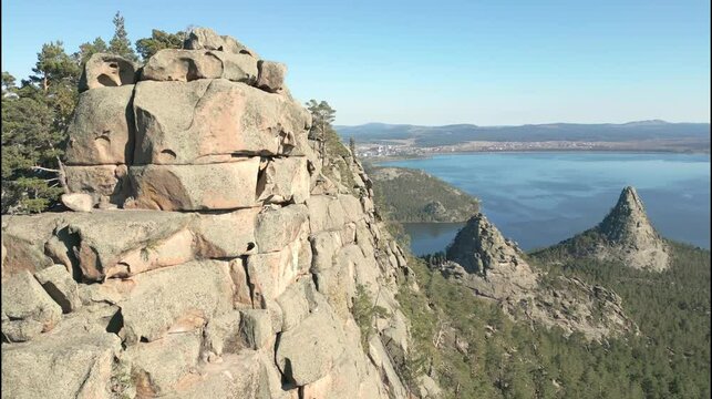 Aerial view of the Rocky Mountains of Kazakhstan. Stony rocks on the background of Lake Borovoe. Fascinating view
