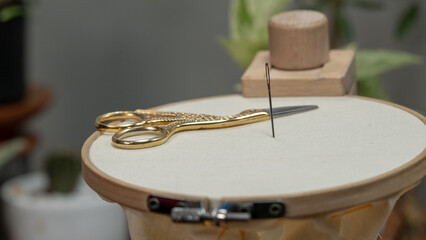 Fototapeta na wymiar Embroidery Essentials: Preparing for a New Project with a Stand Hoop, Fabric, and Threads