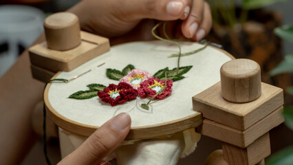 Naklejka na ściany i meble The Art of Handmade Embroidery: Creating a Beautiful Bouquet of Flowers