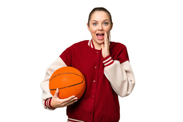 Young blonde woman playing basketball over isolated chroma key background with surprise and shocked facial expression