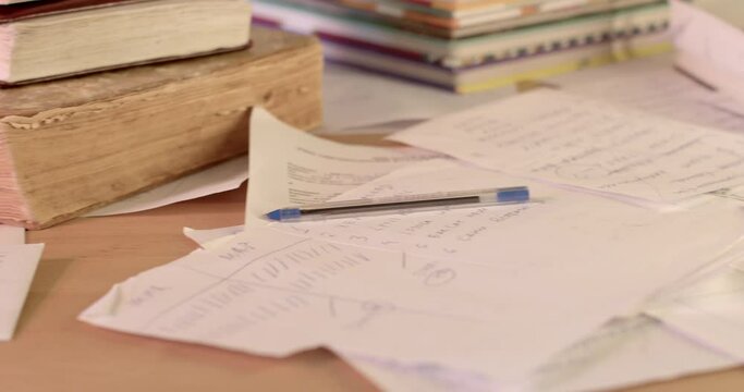 A lot of paper lies on the table, sheets of documents are scattered. Old book, obtaining and using information from paper, secret police. 2.3.23 CZ, Kladno, Polska