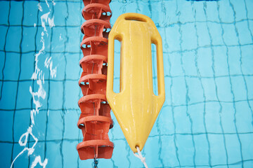 Above, water and a buoy in a pool for safety, life saving and floating help. Board, summer and...