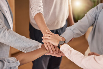 Business people, hands and teamwork in collaboration for meeting, trust or unity and community at the office. Hand of group piling hand together for celebration, success or company goals at workplace