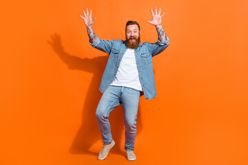 Full size photo of positive excited guy with hands up dancing about new boutique bargain isolated on shine color background