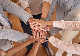 Business people, hands and teamwork in collaboration above for meeting trust, unity and community at office. Top view of group piling hand together for celebration, success or workplace team building