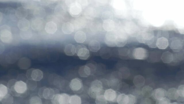 Wavy sea with blurred sunlight reflection in the water