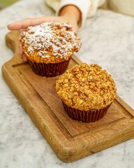 Freshly baked cup cake on a wooden plate
