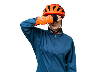 Young cyclist woman over isolated chroma key background covering eyes by hands. Do not want to see something