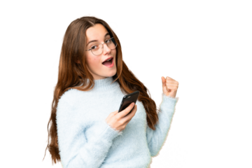 Teenager girl over isolated chroma key background with phone in victory position