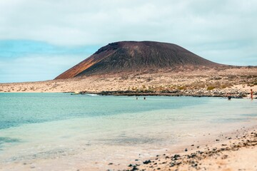 Beautiful ocean with the mountain in the background at the La Graciosa island