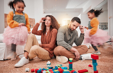 Family, girl playing and parents with stress, frustrated or in living room with a headache or...