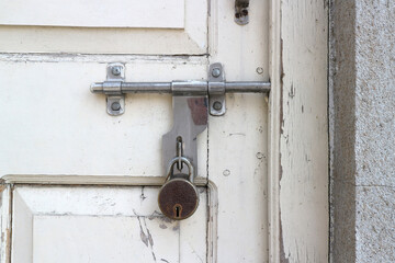 Bolt with a padlock on an old door.