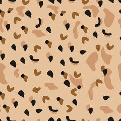 abstract seamless pattern of leopard skin. Beige,  irregular brush spots on a  gold background. Abstract print from the skin of wild animals. Simple irregular design.