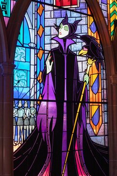 Vertical shot of a colorful stained glass with Disney cartoon characters in a theme park in France
