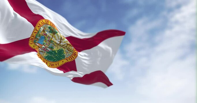 Seamless loop in slow motion of Florida state flag waving on a clear day