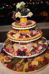 Vertical selective focus of a charcuterie board on a tray with smoked meats, cheeses, and crackers