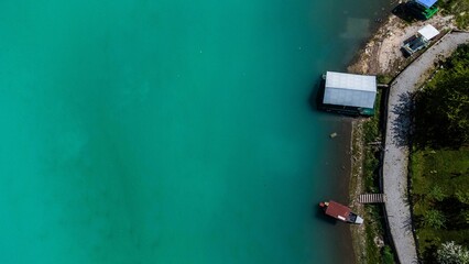 Aerial shot of a building by a road on the coast