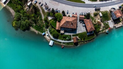 Naklejka premium Aerial shot of country houses by a lake coast