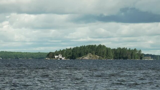 Footage of Muskoka Lake in Gravenhurst, Canada in cloudy sky background