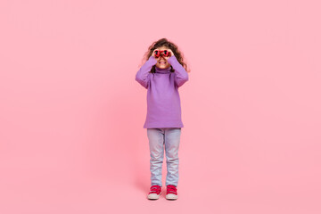Full length photo of pretty funky little child dressed purple pullover hunting you binoculars...