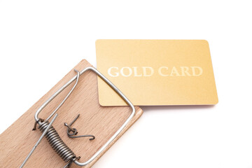 Gold credit card on a mousetrap, Financial trap, Debt, Financial problems.