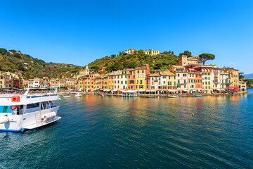 Fototapeta na wymiar Famous village of Portofino, luxury tourist resort in Genoa Province, Liguria, Italy, Europe. Port and colorful houses, Mediterranean sea (Ligurian sea).