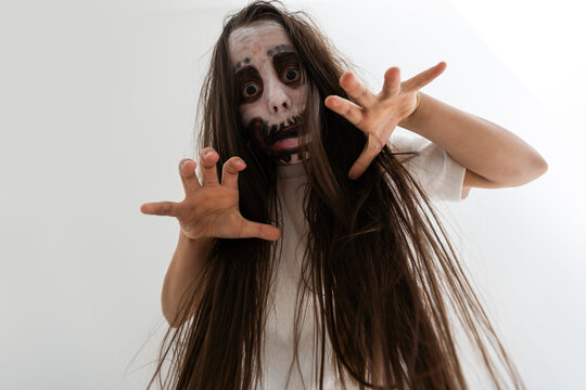 scary girl in white dress from horror film in room