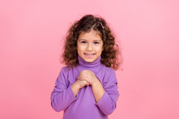 Obraz na płótnie Canvas Photo of dreamy tricky small kid wear violet sweater smiling arms chest isolated pink color background