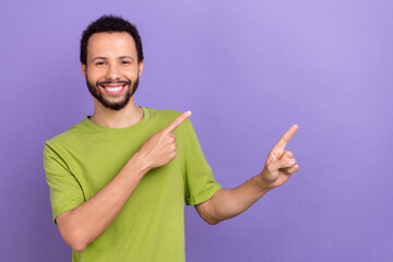 Portrait of positive person toothy smile indicate fingers empty space blank isolated on purple color background