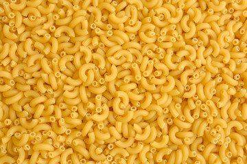 Top view of Italian uncooked pipe pasta. Food texture.