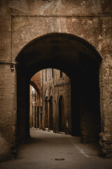 Fototapeta na wymiar Stone arch in Medieval old town