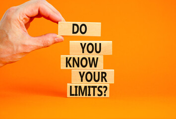 Do you know your limits symbol. Concept words Do you know your limits on wooden block. Beautiful orange table orange background. Businessman hand. Business do you know your limits concept. Copy space.
