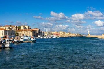 Fototapeta na wymiar Landscape view of the Chania harbor in Crete island, Greece with the lighthouse in the background