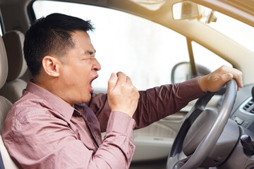 Asian man yawn in car, feels asleep while driving. Concept, campaign to stop driving  with drunk, fatigue exhausted, sick  unwell symptoms or negative feelings that can cause car accident.