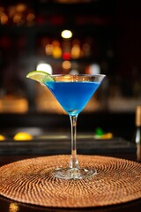 Vertical closeup of a delicious refreshing blue cocktail on a bar counter