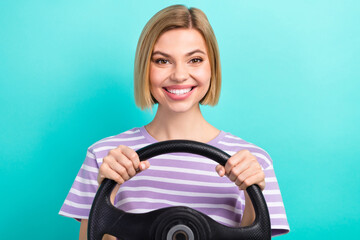 Portrait of optimistic pleasant woman with stylish hairdo striped t-shirt hands hold steering wheel isolated on teal color background