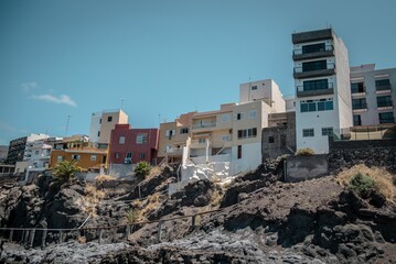 Fototapeta premium Buildings along a cliff by the sea