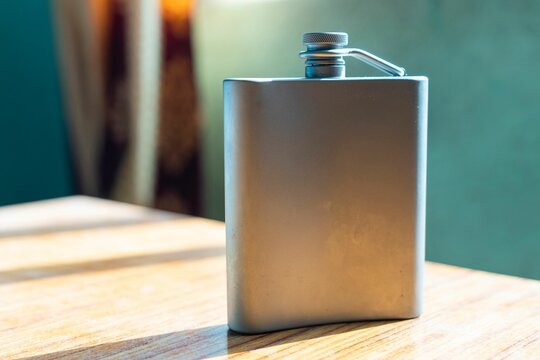 View of a hip flask on wooden table